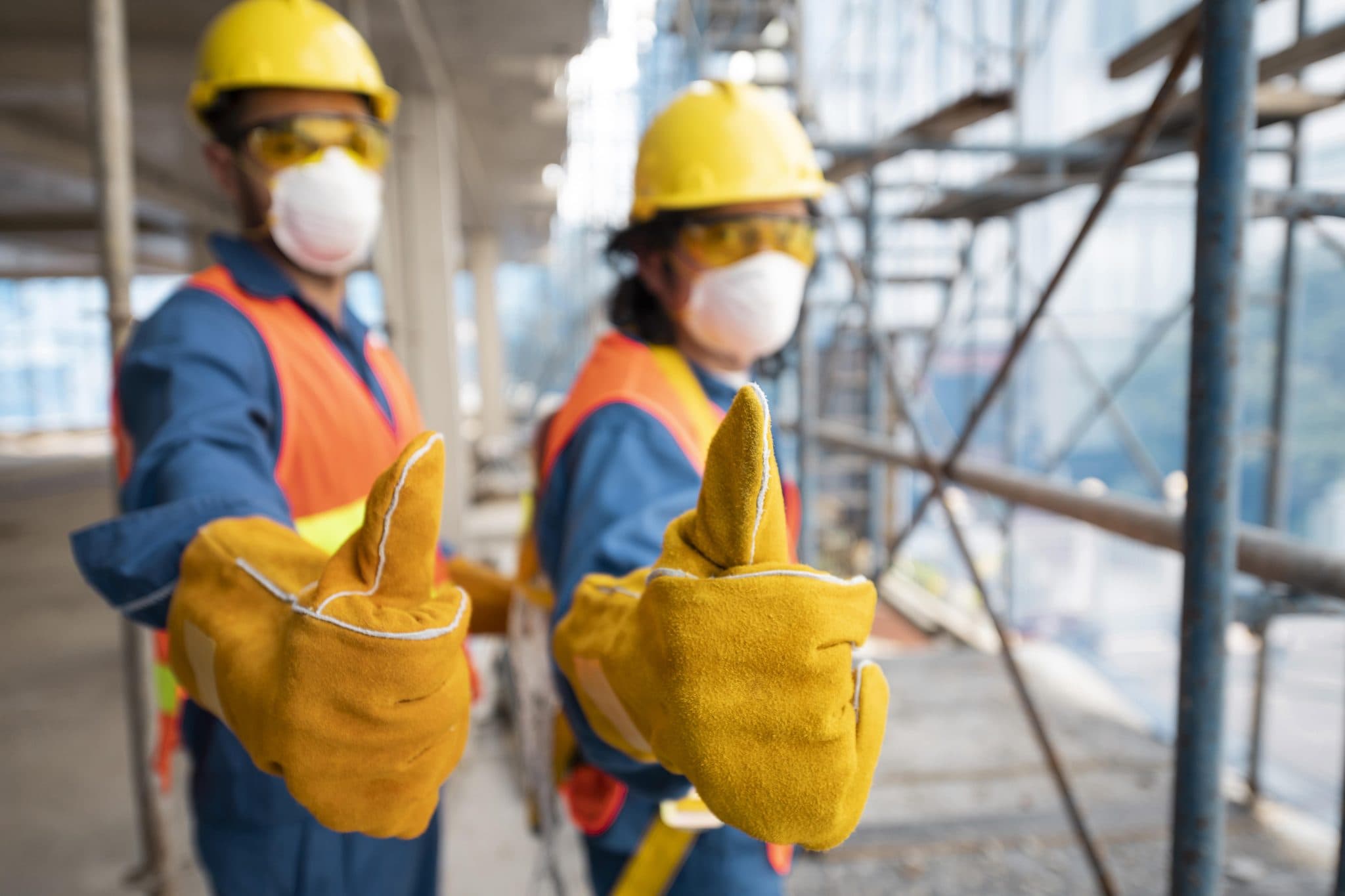 Worker wearing safety equipment with AI visualization overlay showing PPE detection